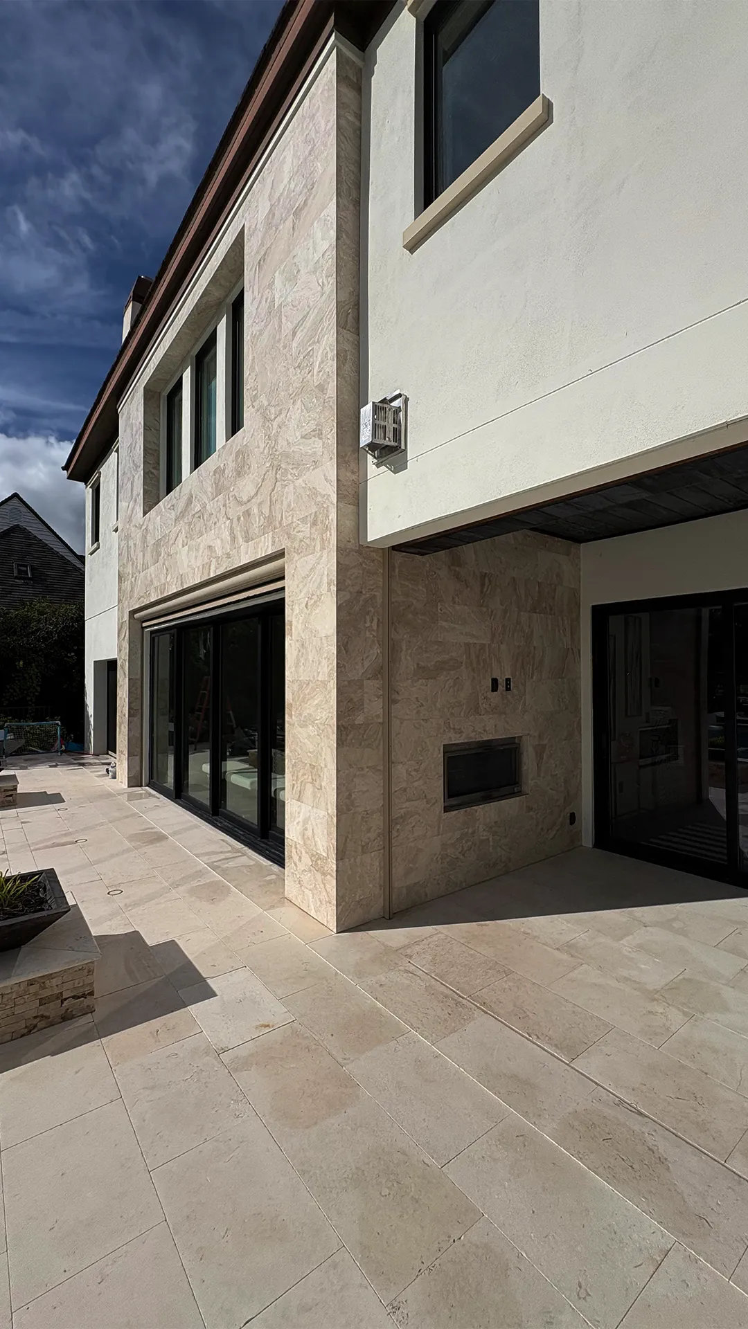 Modern exterior facade with ceramic cladding and dark window frames